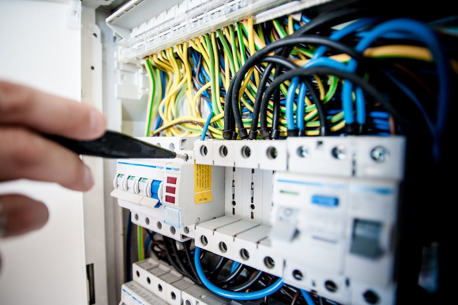 Hand of electrician working on a circuit breaker panel with colorful wires, ensuring safe electrical connections. Trusted electrical contractor Durban. From homes to offices, we provide certified electricians, compliance certificates & emergency electrical services. Trusted electrical contractor Durban. From homes to offices, we provide certified electricians, compliance certificates & emergency electrical services.